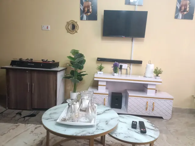 Smart TV wall with soundbar, marble coffee tables and gas cooker